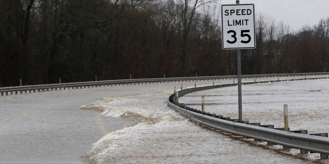 Strong currents from the swollen Pearl River flood over the Old Brandon Road Bridge in Jackson, Miss., Sunday, Feb. 16, 2020.