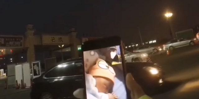 Officer Zhang Lin is patrolling a traffic checkpoint amid the coronavirus outbreak and missed the birth of his child, who he later met via video chat.