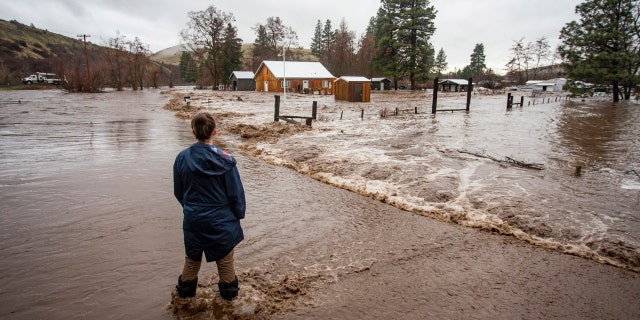 Feb. 6, 2020: Chantel Fuller watches as water floods her home in Thorn Hollow outside of Adams, Ore.