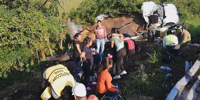 Migrants are treated by first responders following a crash on a highway in San Andres Tuxtla, Veracruz state, Mexico on Tuesday. (Tamara Corro/Reuters TV via REUTERS)
