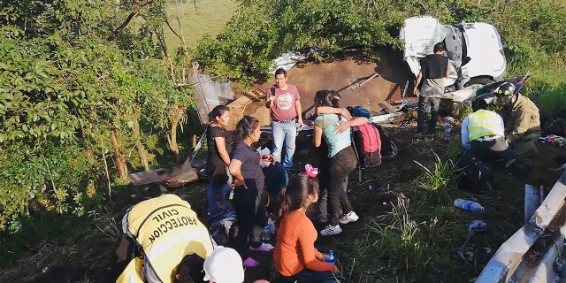 Migrants are treated by first responders following a crash on a highway in San Andres Tuxtla, Veracruz state, Mexico on Tuesday. (Tamara Corro/Reuters TV via REUTERS)