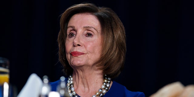 Speaker of the House Nancy Pelosi of Calif., listens as President Donald Trump speaks at the 68th annual National Prayer Breakfast, at the Washington Hilton, Thursday, Feb. 6, 2020, in Washington. (AP Photo/ Evan Vucci)