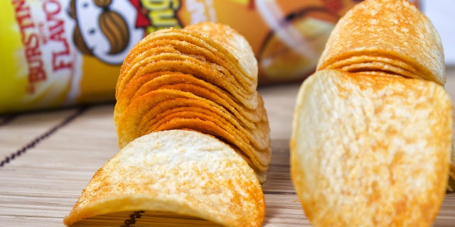 Milan, Italy - April 24, 2013: Pringles potato chips in front of snack size Pringles can. Pringles was invented by Procter and Gamble but in April Procter and Gamble agreed to sell the Pringles brand to Diamond Foods of California.