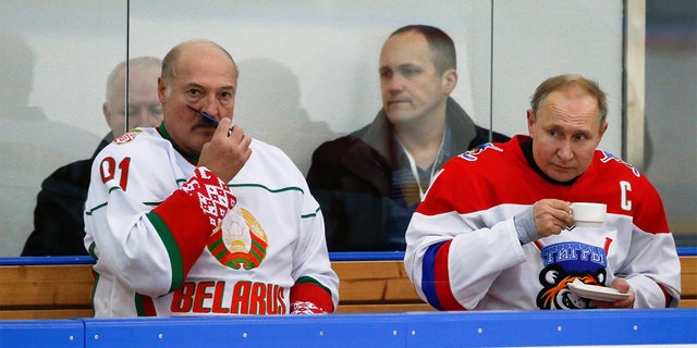 Russian President Vladimir Putin and Belarusian President Alexander Lukashenko take a break during an exhibition ice hockey match in Sochi, Russia.