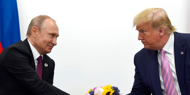 FILE - In this June 28, 2019, file photo, President Donald Trump, right, shakes hands with Russian President Vladimir Putin, left, during a bilateral meeting on the sidelines of the G-20 summit in Osaka, Japan.