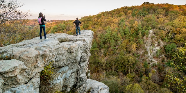 A man and woman on the King and Queen Seat rock formation at Rocks State Park in Maryland. (Edwin Remsburg/VW Pics via Getty Images, File)