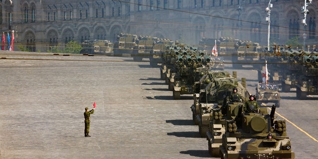 Russian soldiers stand near a convoy of rocket launchers in military parade rehearsal on Red Square, Moscow, in 2008.