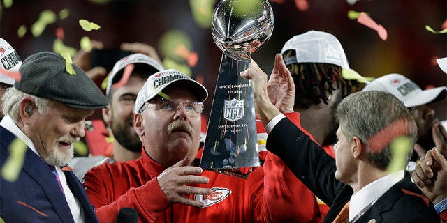 Kansas City Chiefs chairman Clark Hunt, right, hands the trophy to head coach Andy Reid after the Chiefs defeated the San Francisco 49ers in the NFL Super Bowl 54. (AP Photo/Chris O'Meara)