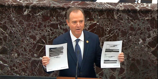 In this image from video, House impeachment manager Rep. Adam Schiff, D-Calif., holds redacted documents as he speaks during the impeachment trial against President Donald Trump, Jan. 22, 2020. (Senate Television via AP)