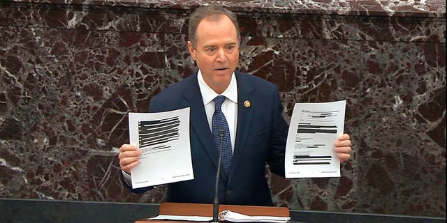 In this image from video, House impeachment manager Rep. Adam Schiff, D-Calif., holds redacted documents as he speaks during the impeachment trial against President Donald Trump, Jan. 22, 2020. (Senate Television via AP)