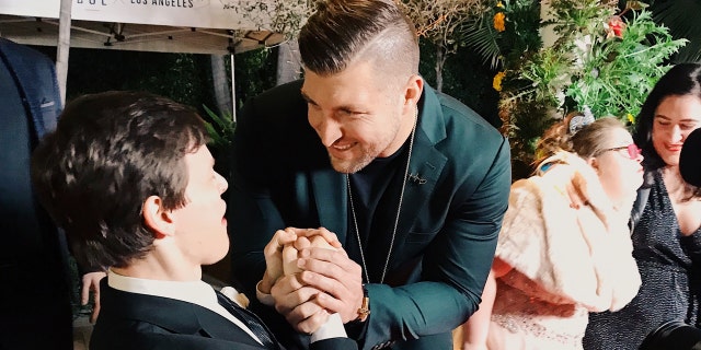 Micah Fowler meeting Tim Tebow on the red carpet at Zoe Church’s Night to Shine in 2019.