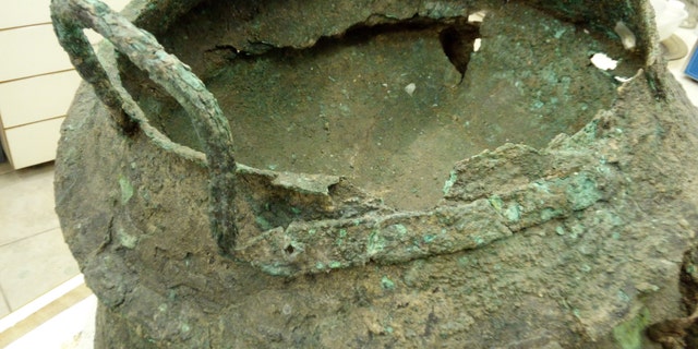 A bronze cauldron discovered at the site. (Credit: T. Rogovski)