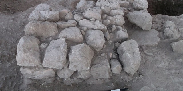 Ancient stone altar and refuse pit at the site. (Tel Aviv University)