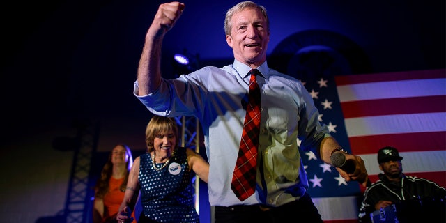 Democratic Presidential candidate entrepreneur Tom Steyer dances onstage with rapper Juvenile singing 