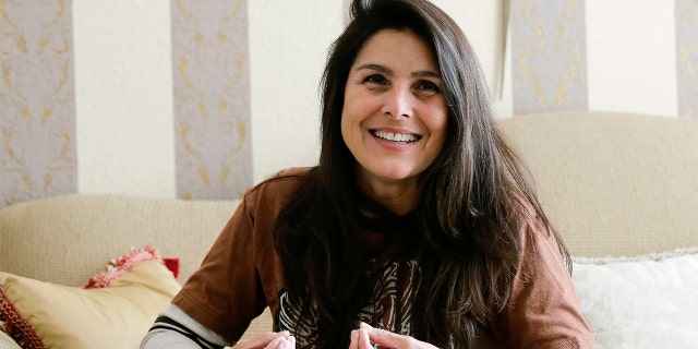 Judith Negron is interviewed at her home in Hialeah, Fla., Wednesday. (AP Photo/Terry Renna)
