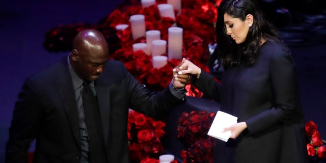 Vanessa Bryant is helped off the stage by former NBA player Michael Jordan after speaking during a celebration of life for her husband Kobe Bryant and daughter Gianna Monday, Feb. 24, 2020, in Los Angeles. (AP Photo/Marcio Jose Sanchez)