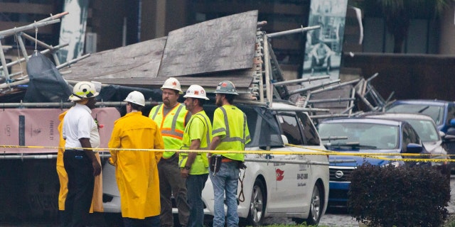 A section of scaffolding at the Four Seasons Hotel construction site in New Orleans collapsed onto at least a dozen cars Wednesday, leaving at least one person injured, as thunderstorms and high winds moved through the area.