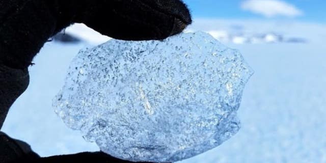 Scientists used a combination of the order of layers of ash deposits from volcanic eruptions and analysis of gas bubbles, seen above, along with DNA from bacteria trapped in the ice -- to date the different parts of the blue ice's surface.