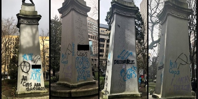 Messages can be seen spray-painted on a war memorial in Portland, Ore. after a demonstration on Saturday.