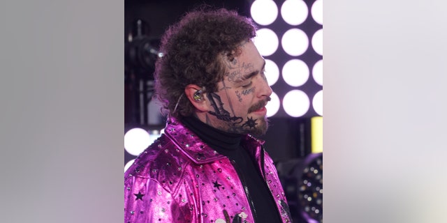 Post Malone shows off his face tattoo while performing during the Times Square New Year's Eve 2020 Celebration. (Photo by Manny Carabel/FilmMagic via Getty)