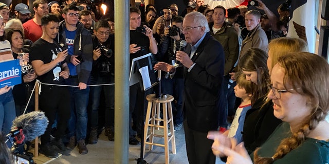 Democratic presidential candidate Sen. Bernie Sanders of Vermont speaks to supporters at a Super Bowl watch party at a sports bar in Des Moines, Iowa on Feb. 2, 2020