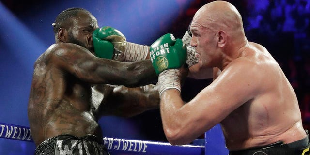 Tyson Fury, of England, lands a right to Deontay Wilder during a WBC heavyweight championship boxing match Feb. 22, in Las Vegas. (AP Photo/Isaac Brekken)