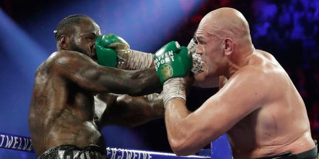 Tyson Fury, of England, lands a right to Deontay Wilder during a WBC heavyweight championship boxing match Feb. 22, in Las Vegas. (AP Photo/Isaac Brekken)