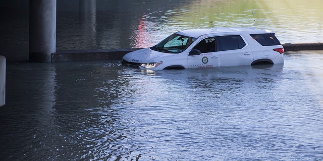 An abandoned vehicle sits stalled in floodwaters from a water main break that inundated the East Loop 610 on Thursday, Feb. 27, 2020 in Houston. (Associated Press)