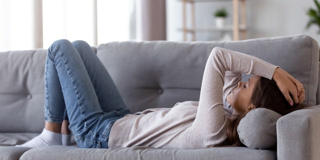 sad woman on couch