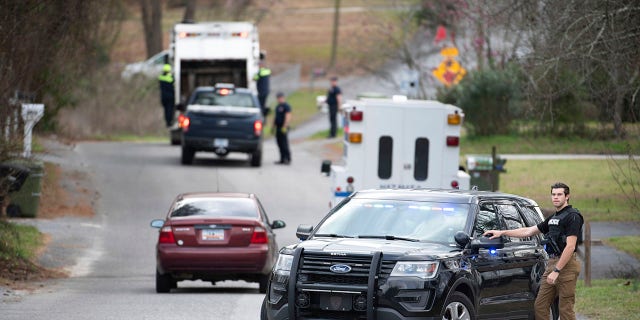 A Cayce police officer blocked an entrance to the Churchill Heights neighborhood on Thursday as investigators continued to search for Faye. (AP Photo/Sean Rayford)