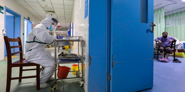 A nurse takes notes in the isolation ward for 2019-nCoV patients at a hospital in Wuhan in central China's Hubei province.