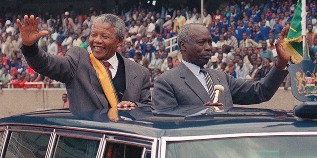 South African leader Nelson Mandela, left, and Kenya President Daniel arap Moi wave to the crowd at a public rally for the African National Congress in Nairobi, Kenya, in 1993. (AP)