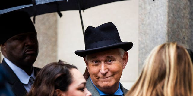 FILE - In this Nov. 12, 2019 file photo, Roger Stone, a longtime Republican provocateur and former confidant of President Donald Trump, waits in line at the federal court in Washington. A Justice Department official tells the AP that the agency is backing away from its sentencing recommendation of between seven to nine years in prison for Trump confidant Roger Stone. (AP Photo/Manuel Balce Ceneta)