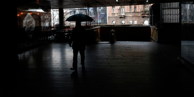 A man walks through an underground passage during rainy day in Belgrade, Serbia, Wednesday, Feb. 5, 2020.