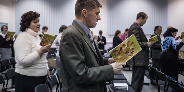 Jehovah's Witnesses sing songs at the beginning of the meeting in Rostov-on-Don. Although Rostov-on-Don is only 80 km away from Taganrog, the organization is not banned there, and people are free to gather and hold meetings. 16 Jehovah's Witnesses are accused of extremist activity in Taganrog, Russia, 80 km away from Rostov-on-Don. (Photo by Alexander Aksakov/For The Washington Post via Getty Images).