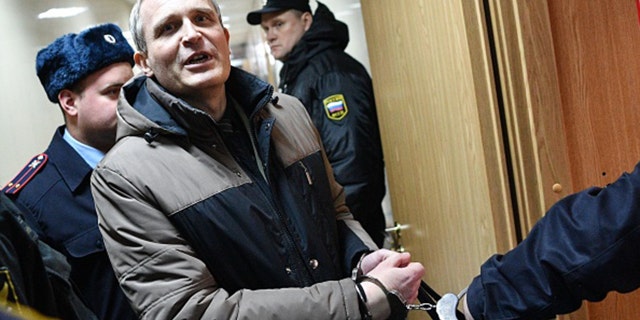 Dennis Christensen, a Danish Jehovah's Witness accused of extremism, is escorted into a courtroom to hear his verdict in the town of Oryol on February 6, 2019. (MLADEN ANTONOV/AFP via Getty Images)