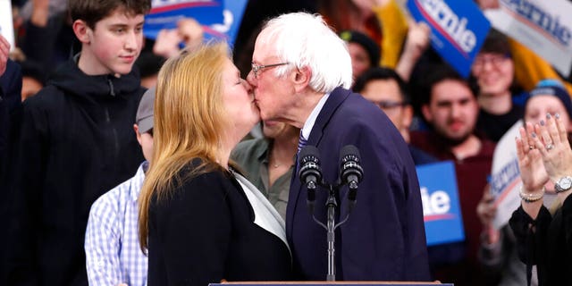 Democratic presidential candidate Sen. Bernie Sanders, I-Vt., kisses his wife Jane O'Meara Sanders, as he speaks to supporters at a primary night election rally in Manchester, N.H., Tuesday, Feb. 11, 2020. (AP Photo/Pablo Martinez Monsivais)