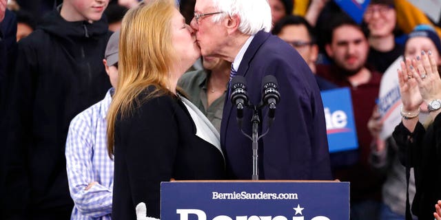 Democratic presidential candidate Sen. Bernie Sanders, I-Vt., kisses his wife Jane O'Meara Sanders, as he speaks to supporters at a primary night election rally in Manchester, N.H., Tuesday, Feb. 11, 2020. (AP Photo/Pablo Martinez Monsivais)