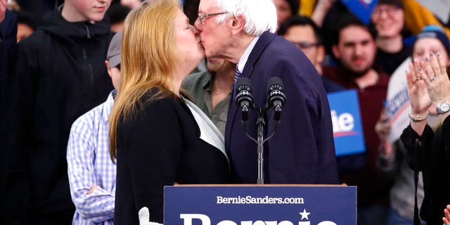 Democratic presidential candidate Sen. Bernie Sanders, I-Vt., kisses his wife Jane O'Meara Sanders, as he speaks to supporters at a primary night election rally in Manchester, N.H., Tuesday, Feb. 11, 2020. (AP Photo/Pablo Martinez Monsivais)