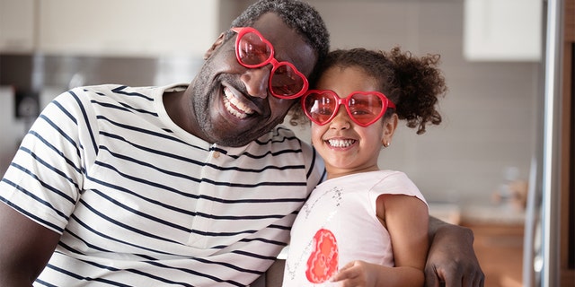 Dad and daughter with heart sunglasses