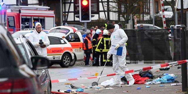 Police and rescue workers stand next to the scene of the incident in Volkmarsen, Germany, on Monday.