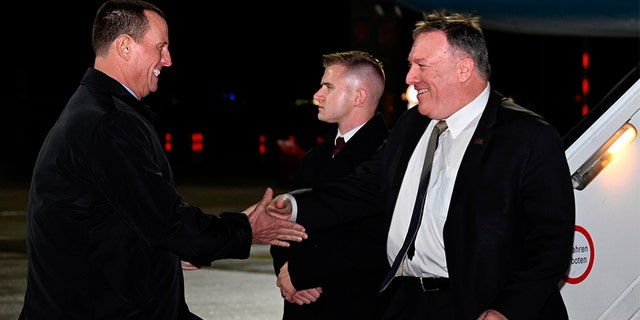 Secretary of State Mike Pompeo is greeted by U.S. ambassador to Germany Richard Grenell as he arrives at Munich International Airport, in Munich, Germany on Thursday, Feb. 13, 2020.