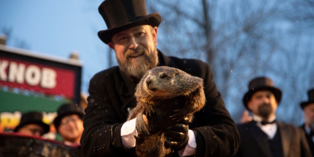 Groundhog Club co-handler Al Dereume holds Punxsutawney Phil, the weather-predicting groundhog, during the 134th celebration of Groundhog Day on Gobbler's Knob in Punxsutawney, Pennsylvania.