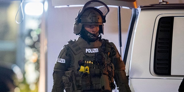 A special forces officer guards the road in front of a house that is searched through by police in Hanau, Germany, Thursday, Feb. 20, 2020. (Associated Press)