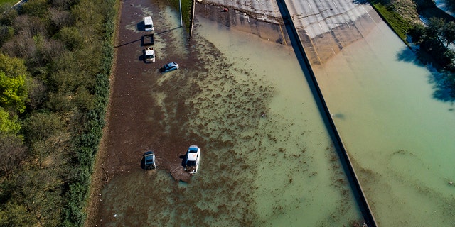 In this aerial photo, water is slowly draining from the freeway after a water main break east of the location flooded all lanes, closing the freeway in both directions, at the intersection of 610 and Clinton Drive, Thursday, Feb. 27, 2020. (Associated Press)