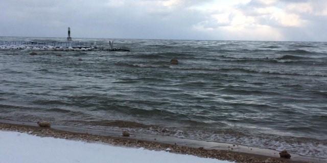 Large ice balls can be seen in the water offshore at Holland State Park in Michigan on Friday.