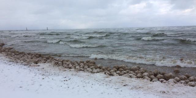 Thousands of ice balls formed and washed along the shore of Lake Michigan on Friday.