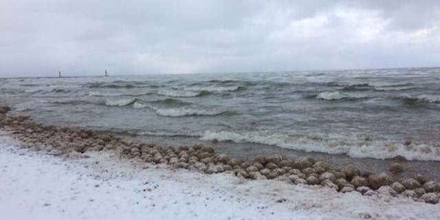 Thousands of ice balls formed and washed along the shore of Lake Michigan on Friday.