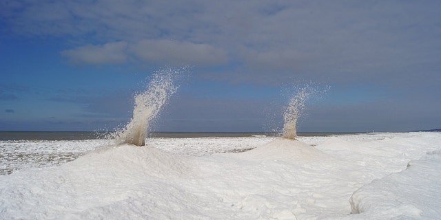 "Ice volcanoes" can be seen erupted on Sunday along the shore of Lake Michigan.