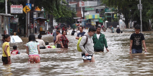 Overnight rains caused rivers to burst their banks in greater Jakarta sending muddy water into residential and commercial areas, inundating thousands of homes and paralyzing parts of the city's transport networks, officials said.
